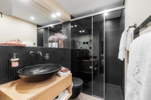 a bathroom with a sink and a shower at VISIONAPARTMENTS Basel - contactless check-in in Basel