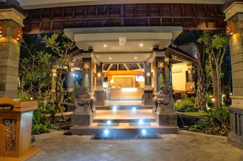 a lobby of a building with a staircase with lights at Kuta Puri Bungalows, Villas and Resort in Kuta