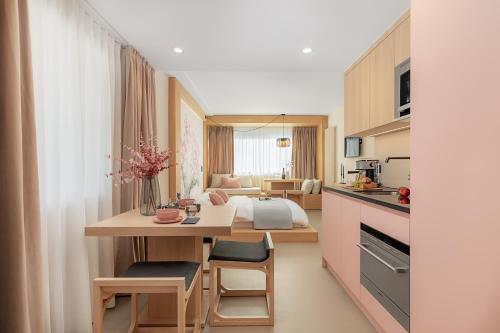 a kitchen and living room with a table and a bed at VISIONAPARTMENTS Basel Nauenstrasse - contactless check-in in Basel