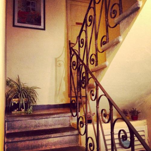a staircase with a wrought iron railing next to a door at BeB Angelini dal 1911 in Lucca