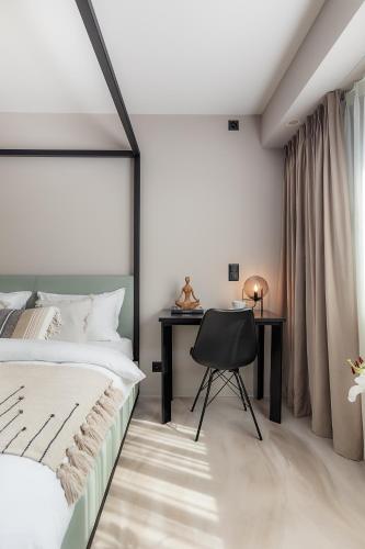 a bedroom with a bed and a desk at VISIONAPARTMENTS Basel - contactless check-in in Basel