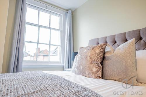 a bedroom with a bed with a large window at Guest Homes - Shaw Street Flat in Worcester