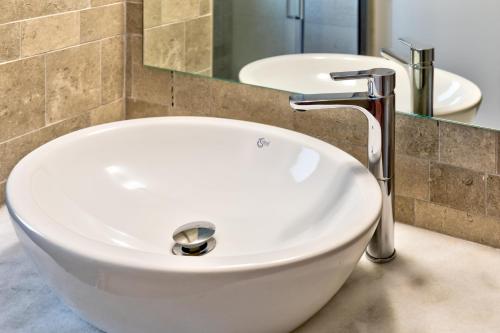 a white sink in a bathroom with two sinks at Villa AmberBlue Pefkos in Pefki Rhodes