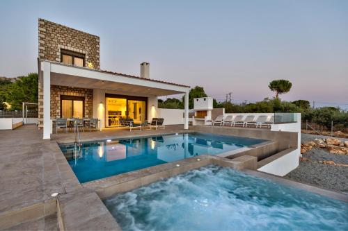 a swimming pool in the backyard of a house at Villa AmberBlue Pefkos in Pefki Rhodes
