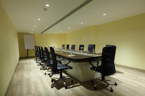 a conference room with a long table and chairs at Click Hotel Transport Nagar in Lucknow