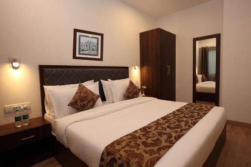 a bedroom with a large bed in a hotel room at Click Hotel Transport Nagar in Lucknow