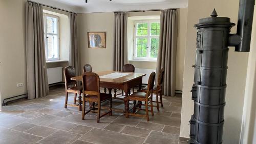 a dining room with a table and chairs at Propstei Wechterswinkel in Wechterswinkel