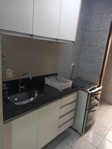 a kitchen with a sink and a counter top at Casa 80m apenas 6km do Morro do Careca Natal in Natal