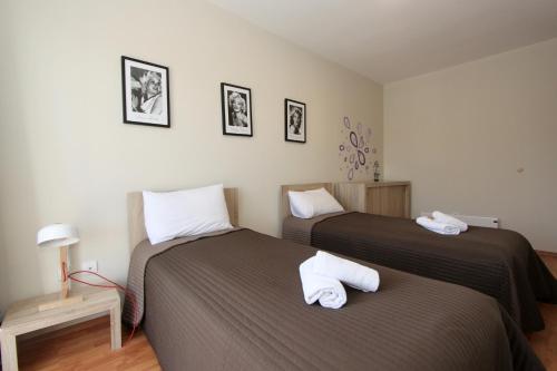 two beds in a small room with twoermott at Cozy apartments in Belgrade, Čukarica, Železnik, free parking and WiFi in Belgrade