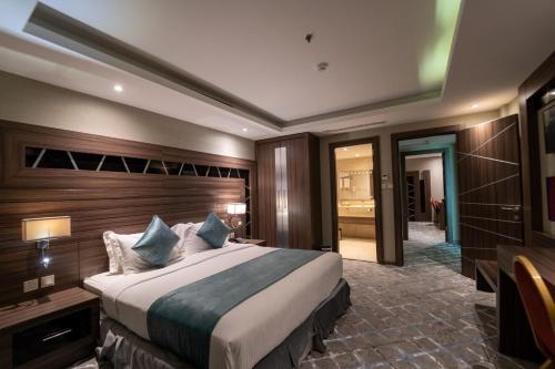 a hotel room with a large bed and a bathroom at Sumou Al Khobar Hotel in Al Khobar