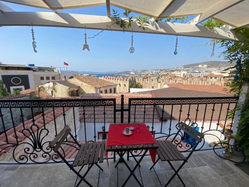 a table and chairs on a balcony with a view at Villa Ephesus Hotel in Kusadası