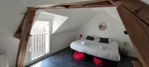 a bedroom with two beds and a large window at Noyers Val de Cher in Noyers-sur-Cher