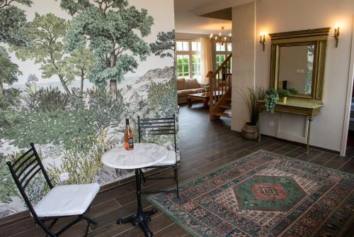 Cette chambre comprend une table, deux chaises et un tapis. dans l'établissement maison d'hôtes ed.André 10 personnes, à Azay-sur-Cher