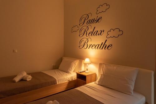 a bedroom with two beds with clouds on the wall at Garden House Preveza in Preveza