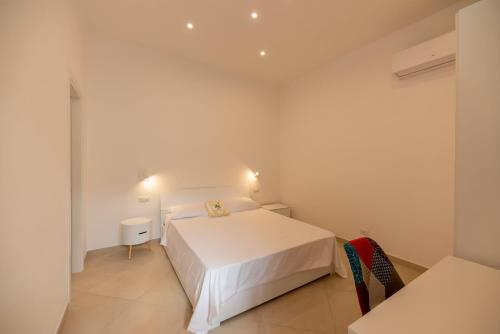 a bedroom with a white bed in a room at Marina Grande Holiday Apartment in Capri in Capri