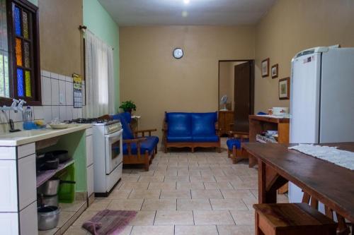 a kitchen with a table and a white refrigerator at Casa de Praia - Ilha Comprida in Ilha Comprida