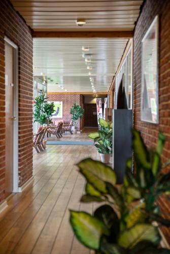 a hallway with plants and benches in a building at Hotel Lynggaarden in Herning