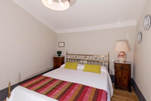 a bedroom with a bed and two night stands at I Casali di Villa Benveduti in Gubbio