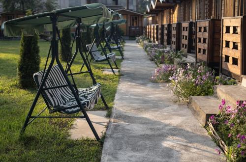 a row of park benches sitting next to a sidewalk at At the sea in Sukhum