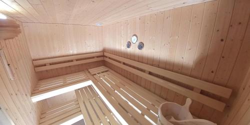 a sauna with a bench and a clock on the wall at Ferienhaus Maliet - Spacious Holiday Home with Mountain view in Pany