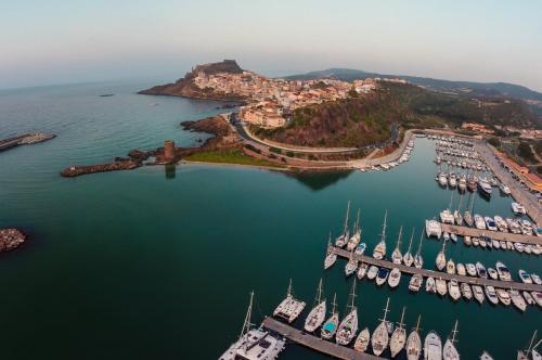 an aerial view of a marina with boats in the water at La terra del benessere in Castelsardo
