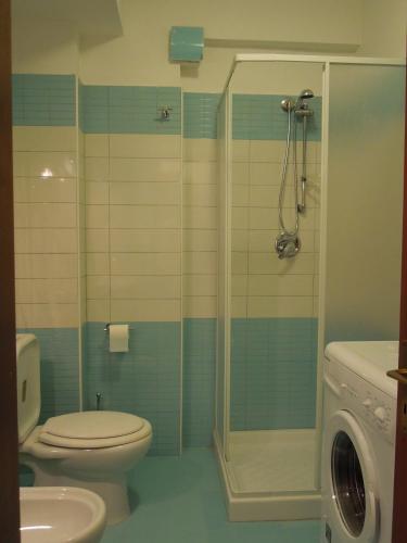 a bathroom with a shower and a toilet and a sink at Icaro in Letojanni
