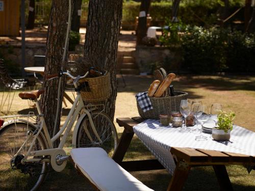 a picnic table with a bike parked next to a tree at Domotel Kastri in Athens