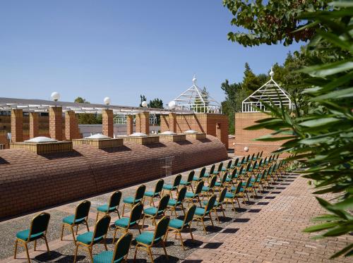a row of chairs are lined up on a patio at Domotel Kastri in Athens