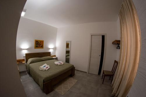 a bedroom with a bed with two towels on it at La terra del benessere in Castelsardo