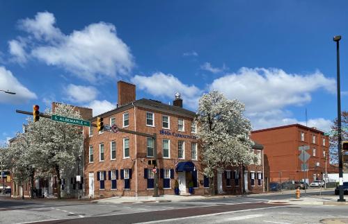 a city street with a tall brick building at 1840s Carrollton Inn in Baltimore