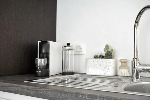 a kitchen counter with a coffee maker and a sink at Cosy Studio Testerep , Newly Renovated in Ostend