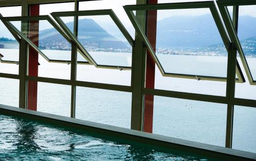 a swimming pool with a view of the water at Il Porticciolo in Laveno-Mombello