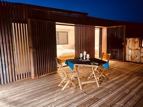a room with a table and chairs on a deck at CASA DA TRINCHEIRA , turismo de habitação in Pinhel