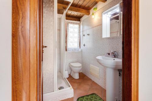 a small bathroom with a sink and a toilet at Countryside Sicily House in Pagliaia