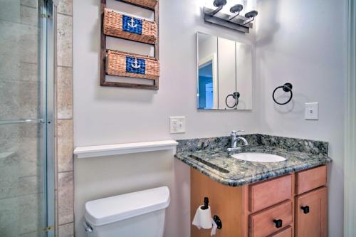 a bathroom with a sink and a toilet and a mirror at Cape May Quad with Grill - 7 Blocks to Beach! in Cape May