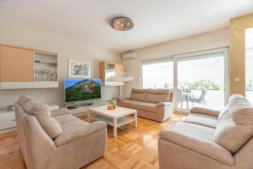 een woonkamer met 2 banken en een tv bij Apartment Relax whit big terrace 170m2 Near the Beach in Split