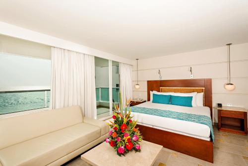 Postel nebo postele na pokoji v ubytování Hotel Dann Cartagena