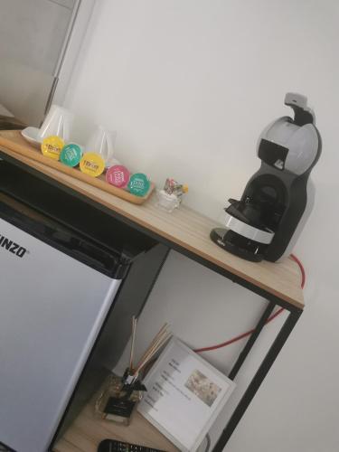 a wooden shelf with a coffee maker on it at Jacuhomespa13 in Vitrolles