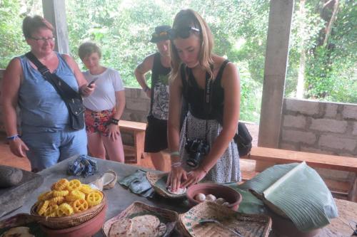 a woman standing next to a table with food at The Esence of Sri Lanka in Ahungalla