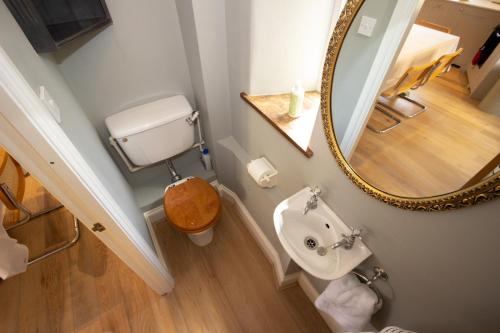 a bathroom with a sink and a mirror at The Barn, Stourton in Sutton under Brailes
