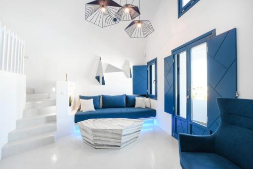 a blue living room with a blue couch and stairs at Blue White Residence in Monolithos
