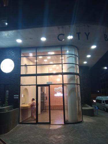 a large glass window of a building with a person inside at Maboneng City Building Free WiFi and Swimming pool in Johannesburg