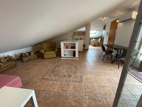 a living room with a table and chairs at Casa Via Vigo in Acireale