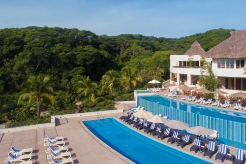 an aerial view of a resort with a swimming pool at Grand Matlali Suites & Villas Riviera Nayarit in Cruz de Huanacaxtle