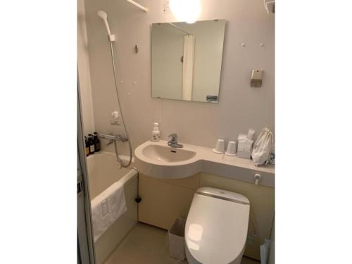 a bathroom with a toilet and a sink and a mirror at Ise Pearl Pier Hotel - Vacation STAY 60823v in Ise