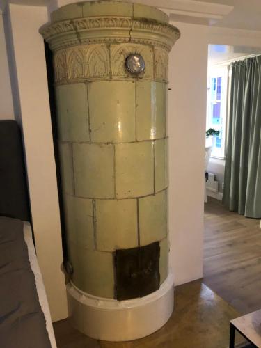 a stone pillar in a room with a clock on it at Rådstugugatan 32 in Nora