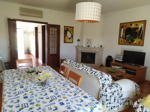 a living room with a dining room table with a table cloth at SW Beach House Zambujeira do Mar in Zambujeira do Mar