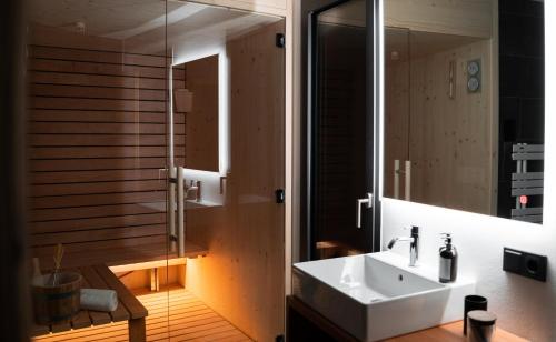 a bathroom with a sink and a mirror at Chalet Insignis in Santa Cristina in Val Gardena