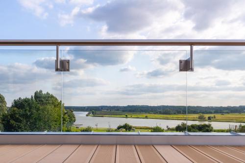 a view from the deck of a house overlooking a river at Hotel & SPA Hetman in Siedlce