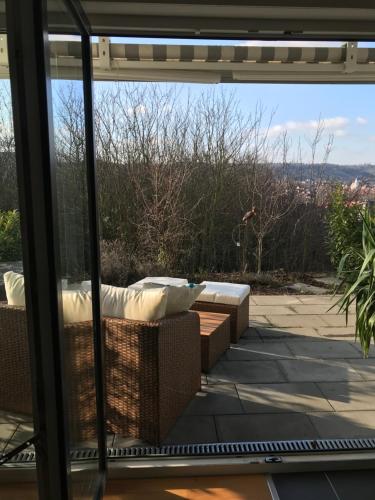 a patio with a couch and a view of the city at Ferienwohnung Schönblick in Sommerhausen